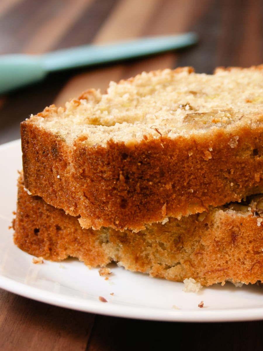 two large slices of banana bread stacked on top of eachother and served on a plate