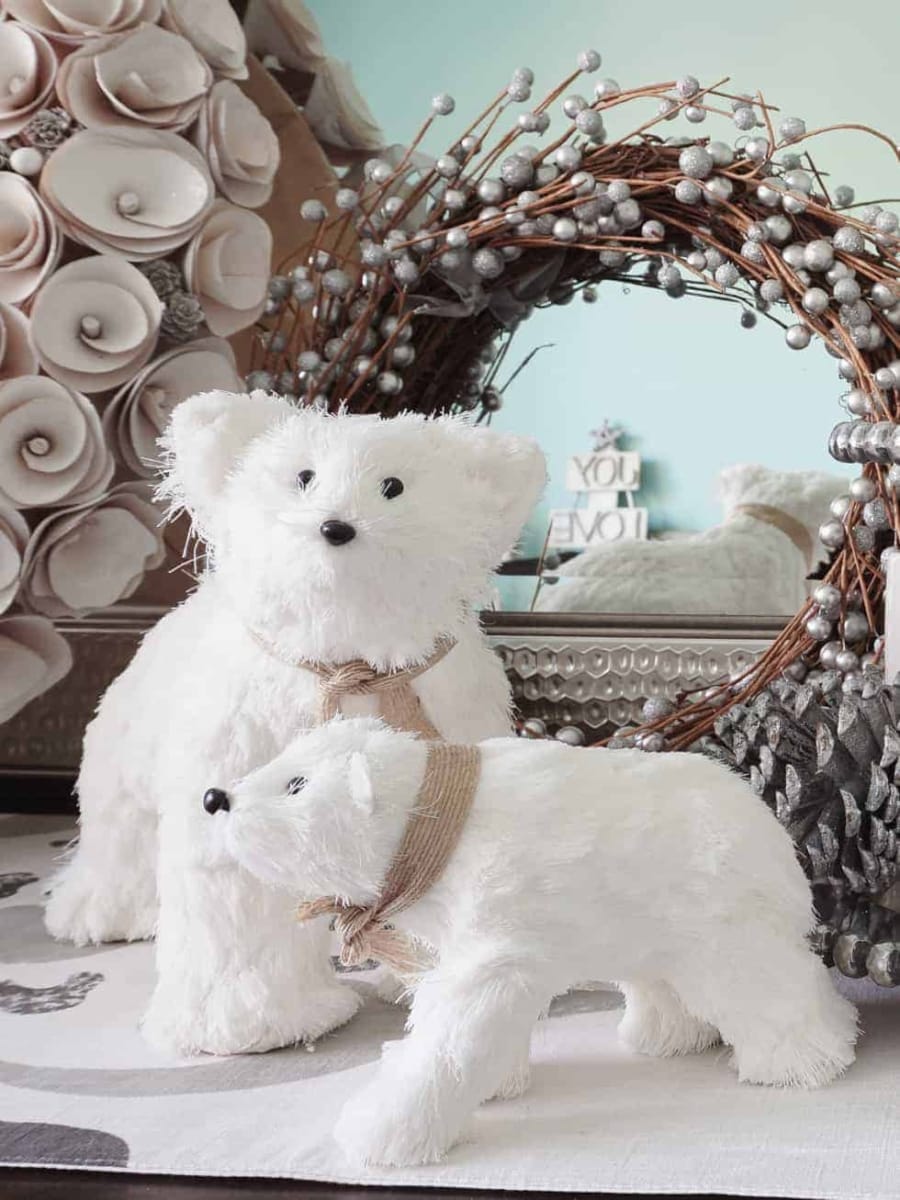 A set of white polar bears and wreaths for Christmas dining room decor.