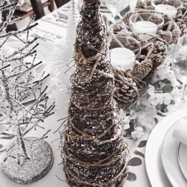 Tree decor of all sizes setup for a dining room centerpiece.