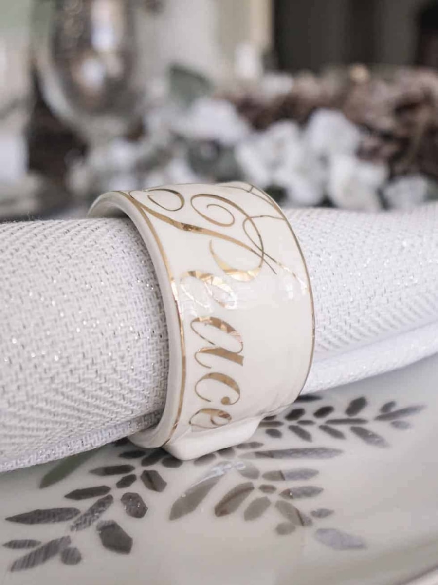 A peace napkin ring over a snowflake place setting.