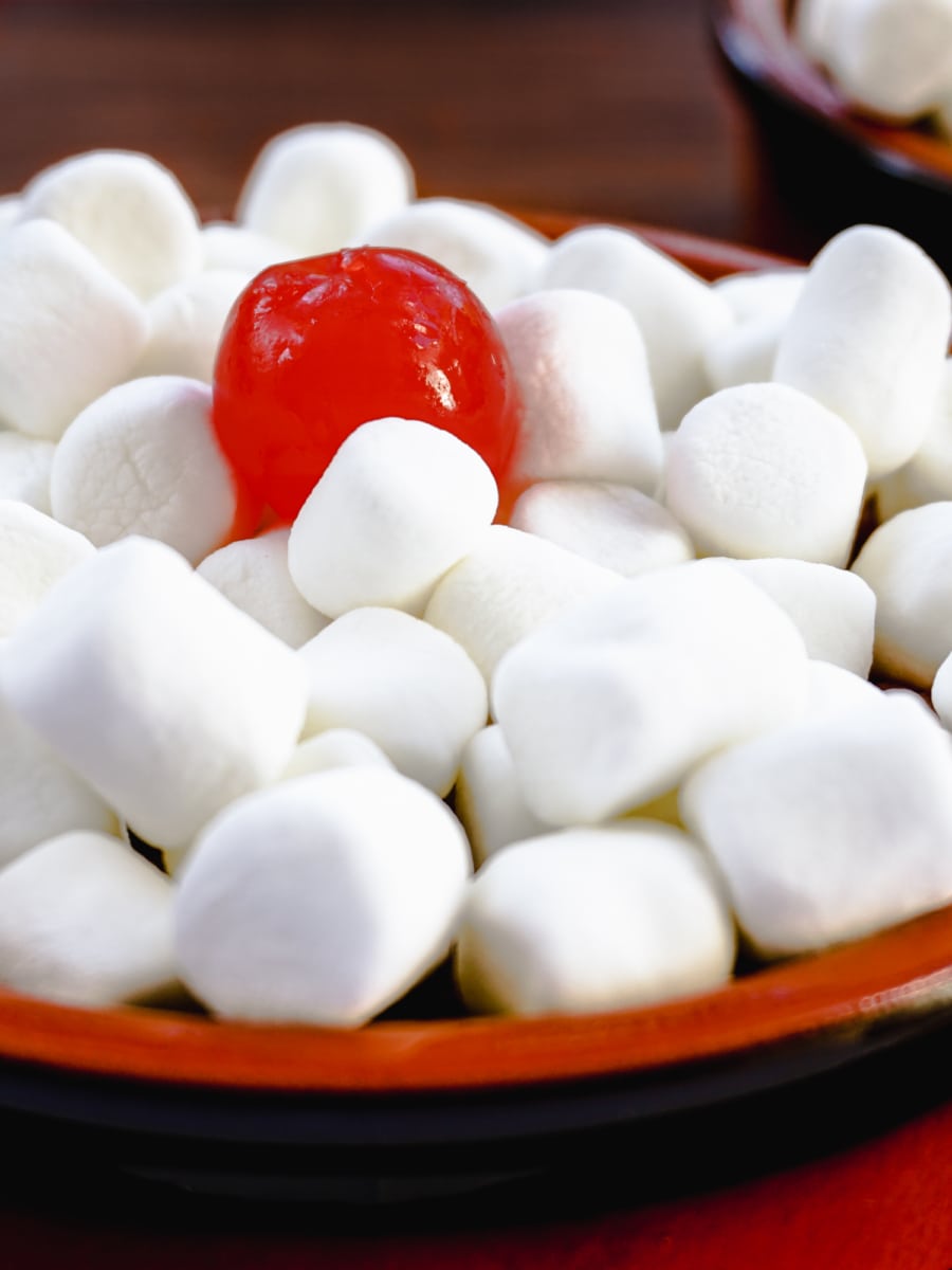 sweet potato casserole topped with marshmallows and a cherry