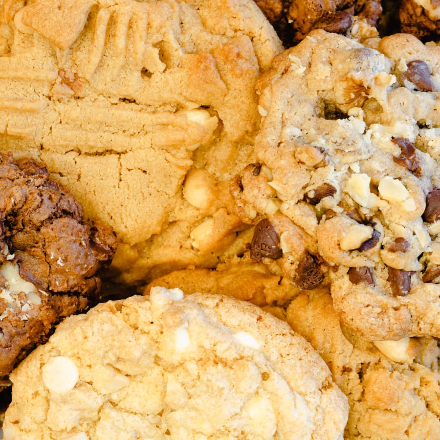 stack of cookies in a cookie tin ready to be wrapped as a gift for friends or family