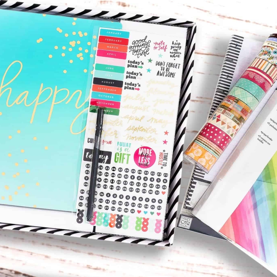 the happy planner kit along with accessories laid out on a table