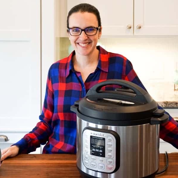 valerie smiling next to an instant pot in her kitchen