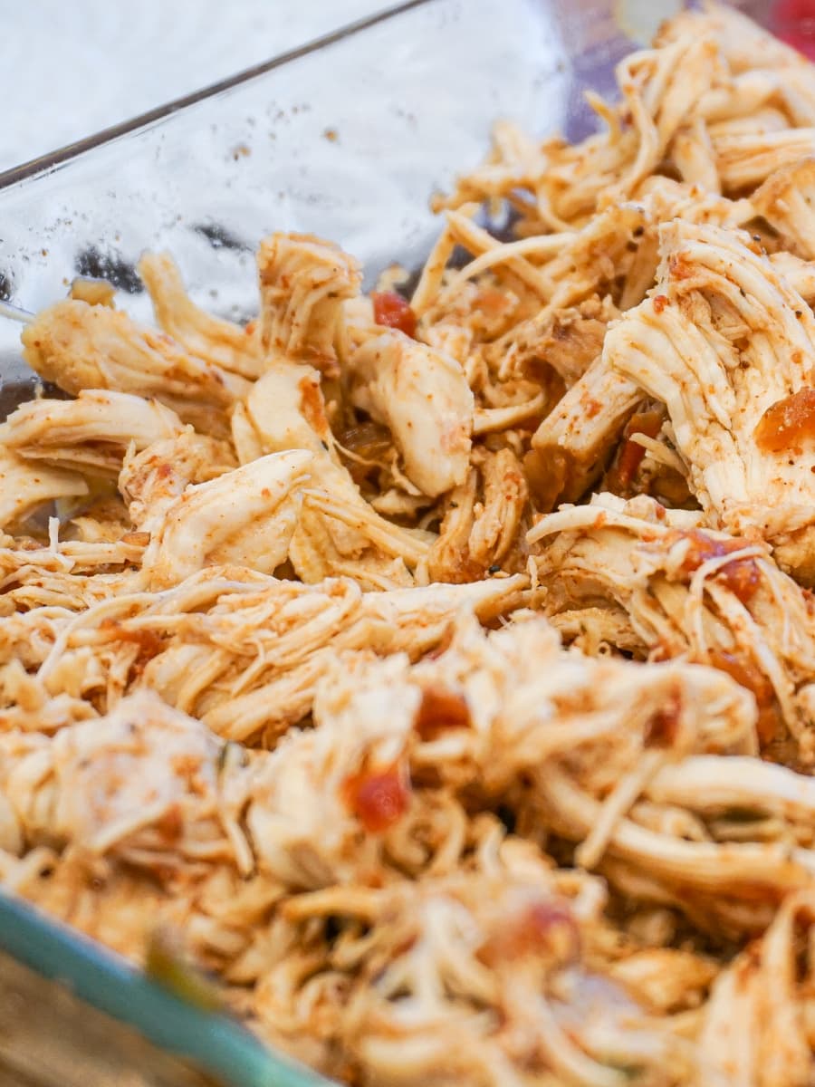 shredded salsa chicken breasts in a glass dish