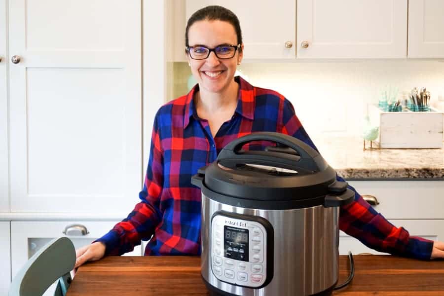 valerie smiling next to an instant pot in her kitchen