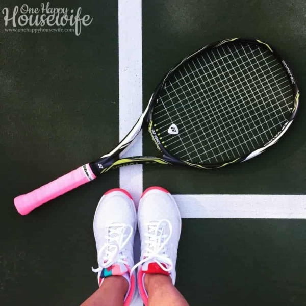 tennis racket laying on the court at my feet