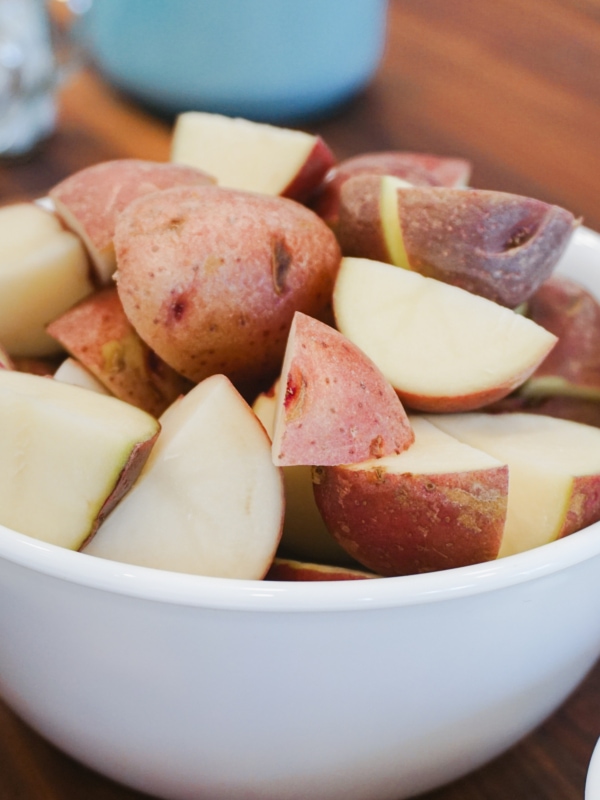 Cut up baby red potatoes in a bowl to make Instant Pot Chicken Soup.