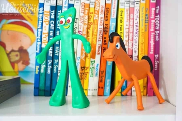 Toys and Dr Seuss Book Collection Organized on Shelves in a Boy's Bedroom