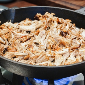 cooking carnitas in a skillet on the stove