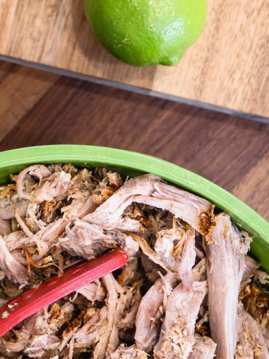 a large bowl of shredded pork carnitas