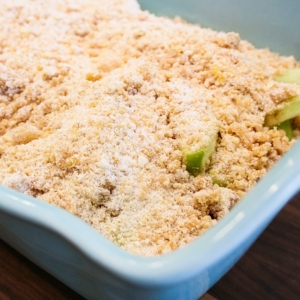 sliced apples covered with apple crumble topping mix