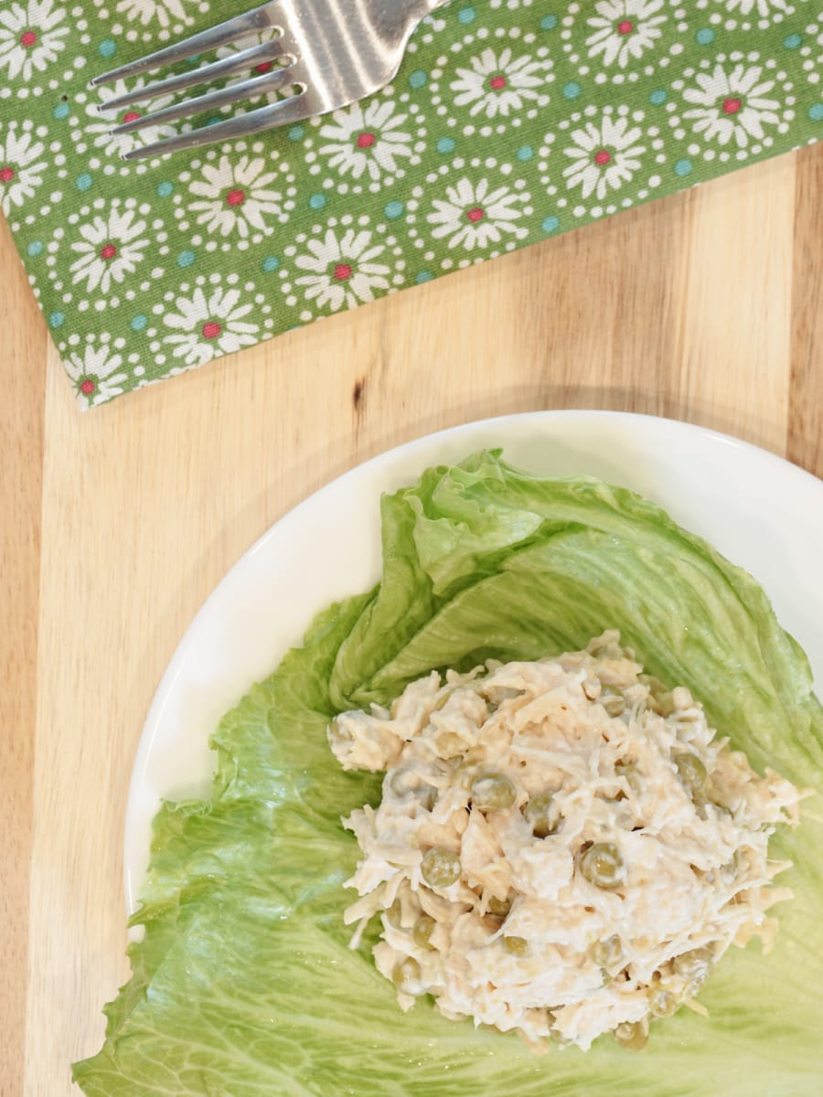 overhead shot of lettuce with a ball of chicken, peas, and mayo