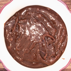 overhead shot of chocolate lava cake in a ramekin ready to be baked