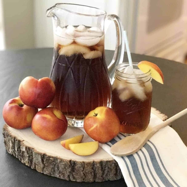 a refreshing summer tea on a log piece with apples