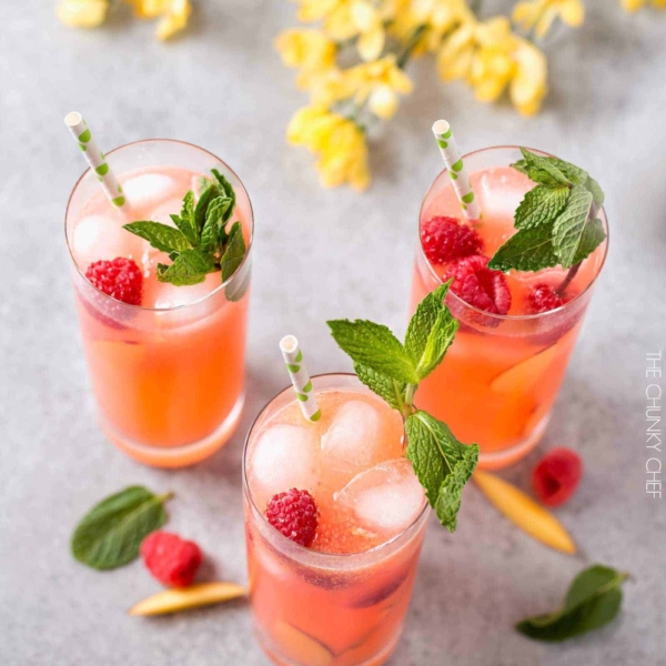 a Raspberry, peach and lemonade mixed drink served in two different cups