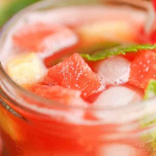 close up of a watermelon and pineapple lemonade in a glass cup