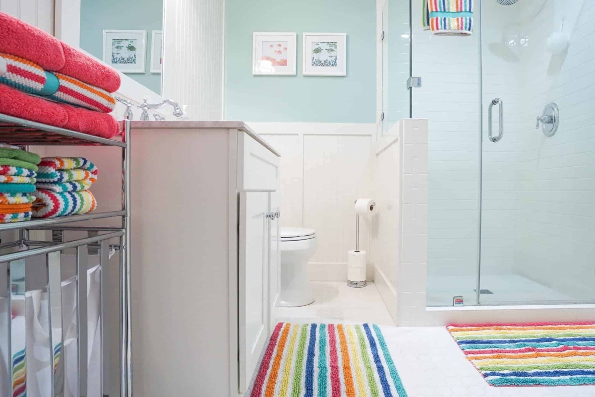 White cabinets and tile provide a canvas for endless bathroom color ideas.