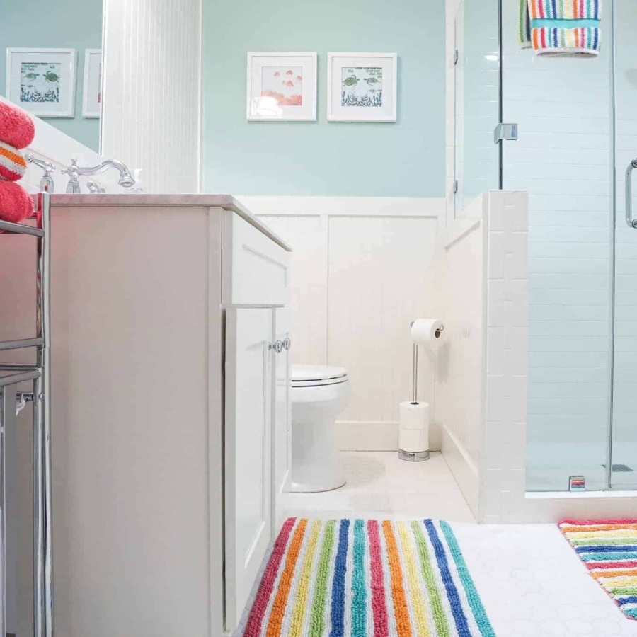 White cabinets and tile provide a canvas for endless bathroom color ideas.