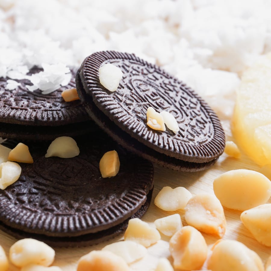 three thin oreos surrounded by nuts and coconut bits