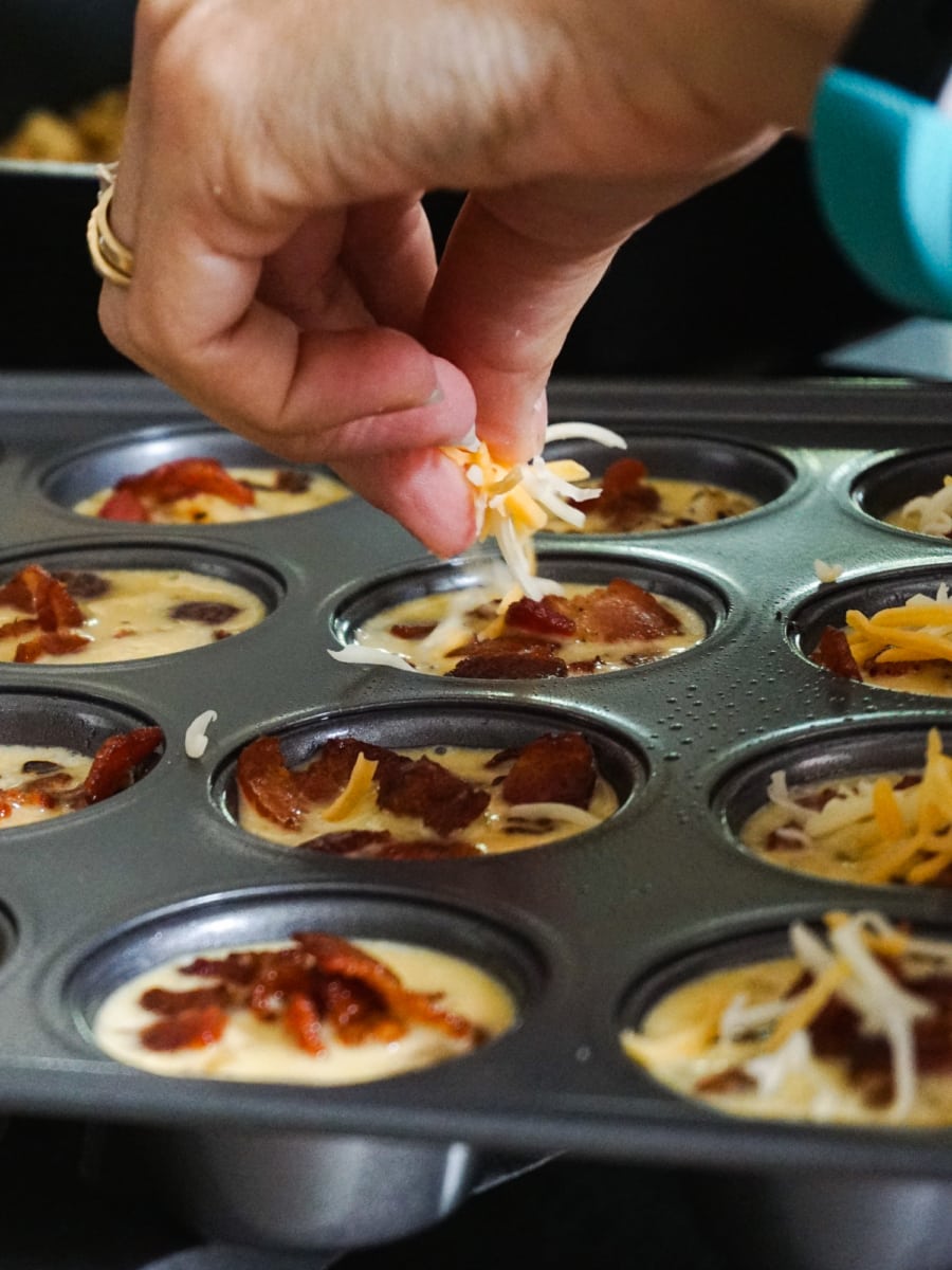 Adding cheese to Frittata Poppers.