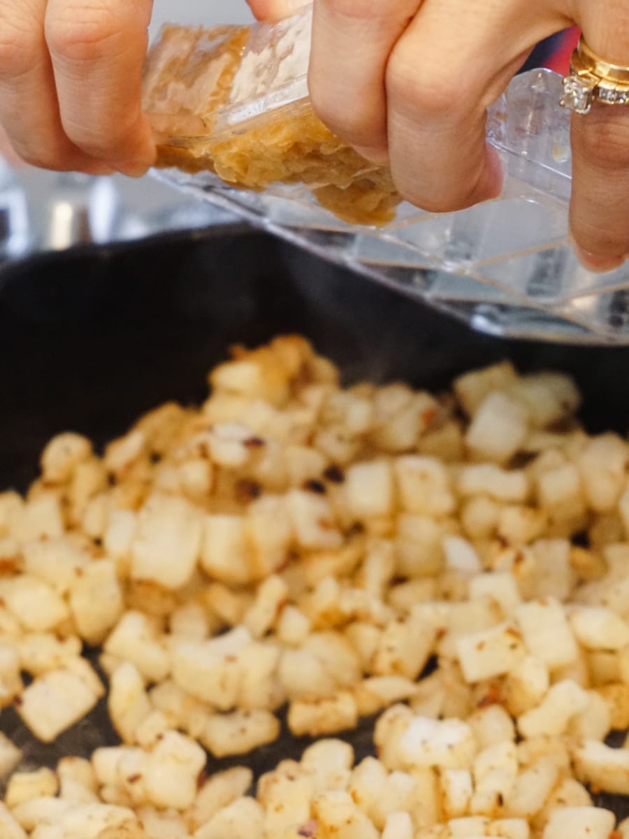 Cooking Pop and Cook sauteed onions for Frittata Poppers.