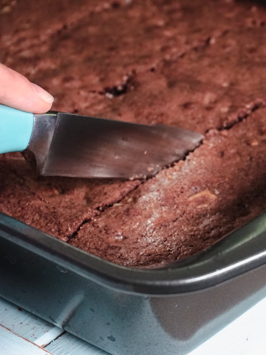 cutting up pieces of brownies with a knife