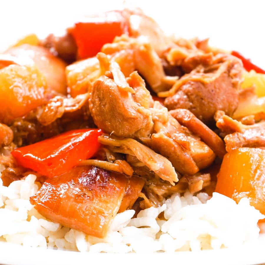 hawaiian chicken served over a bed of rice on a plate