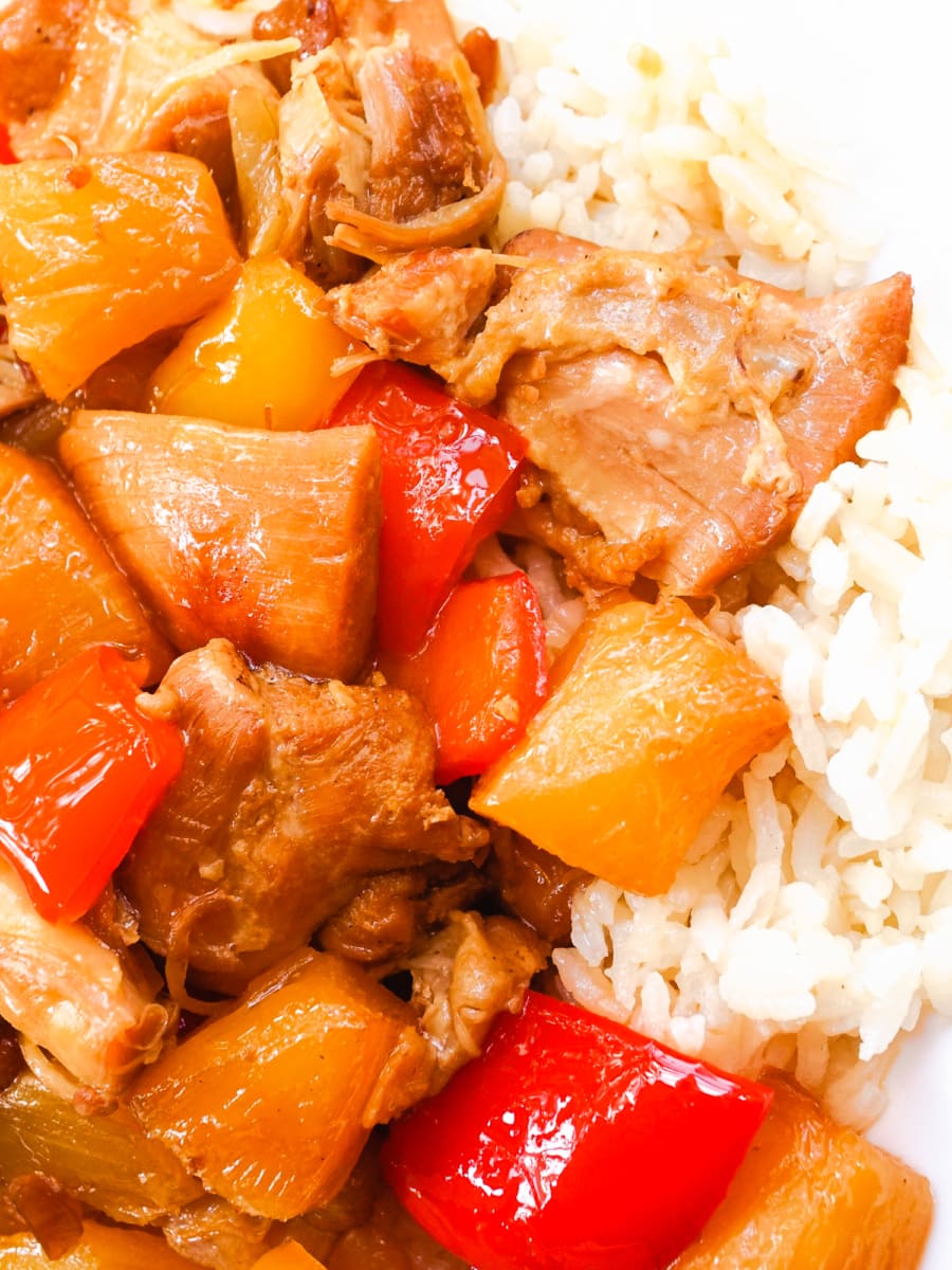 a plate of hawaiian chicken served over rice.