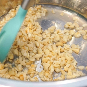 Toasting macadamia nuts for Instant Pot Hawaiian Chicken.