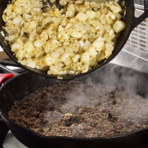 Cooking the filling for beef and potato empanadas