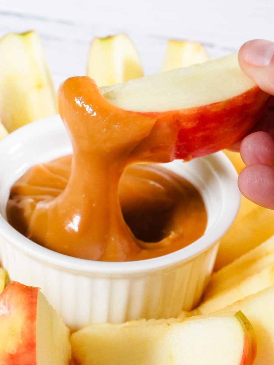 dipping an apple slice in dulce de leche