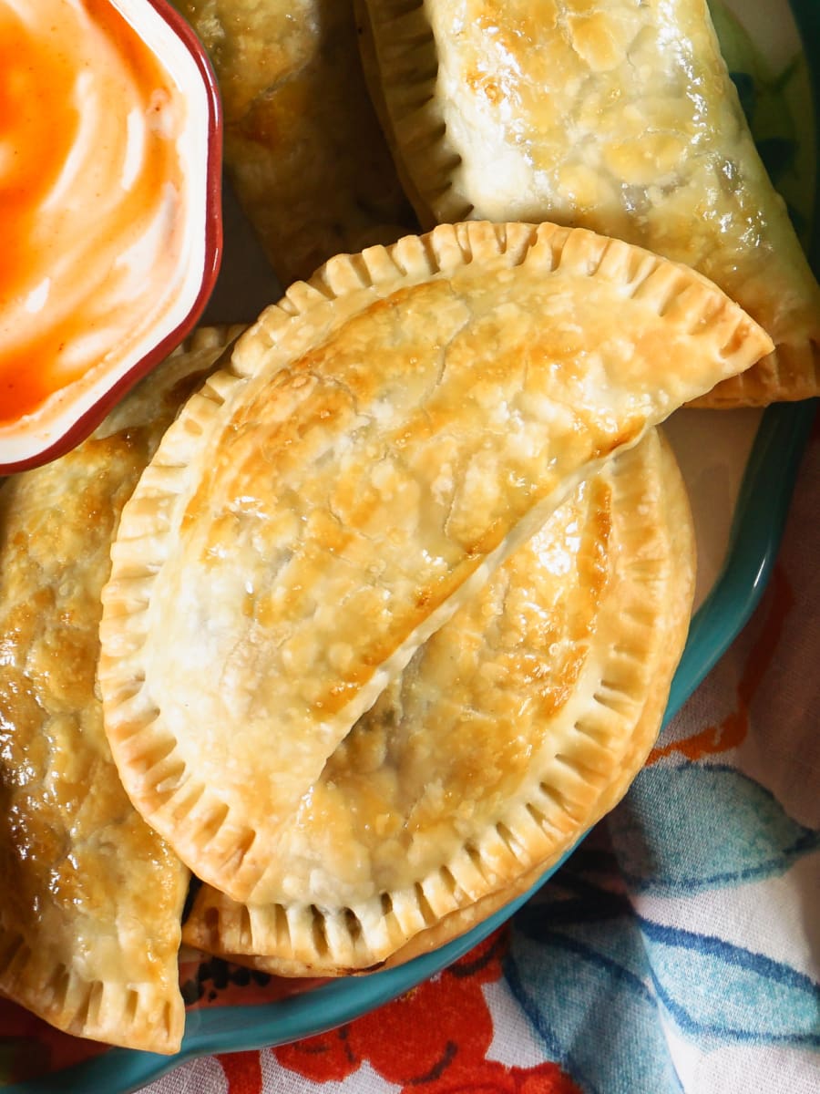 Beef and potato empanadas next to a bag of simply potatoes