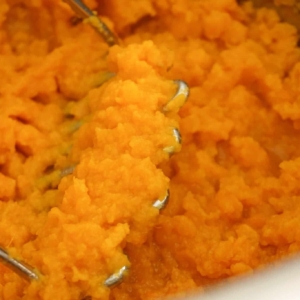 Mashing sweet potatoes for sweet potato casserole in the Instant Pot