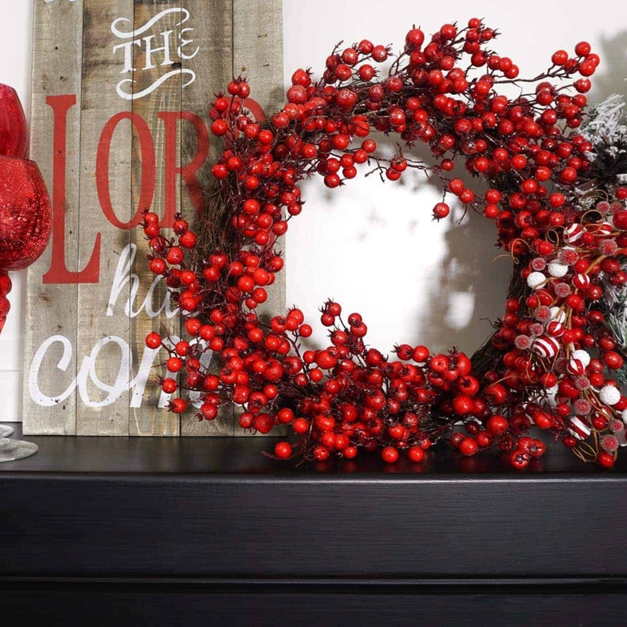 decorating a Christmas mantel with signs and wreaths