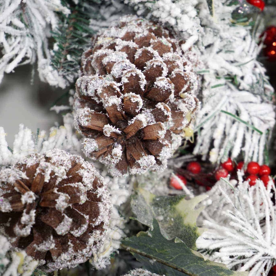 decorating a mantel with wreaths for Christmas