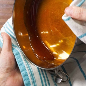 adding caramel flan ingredients to a flan pan