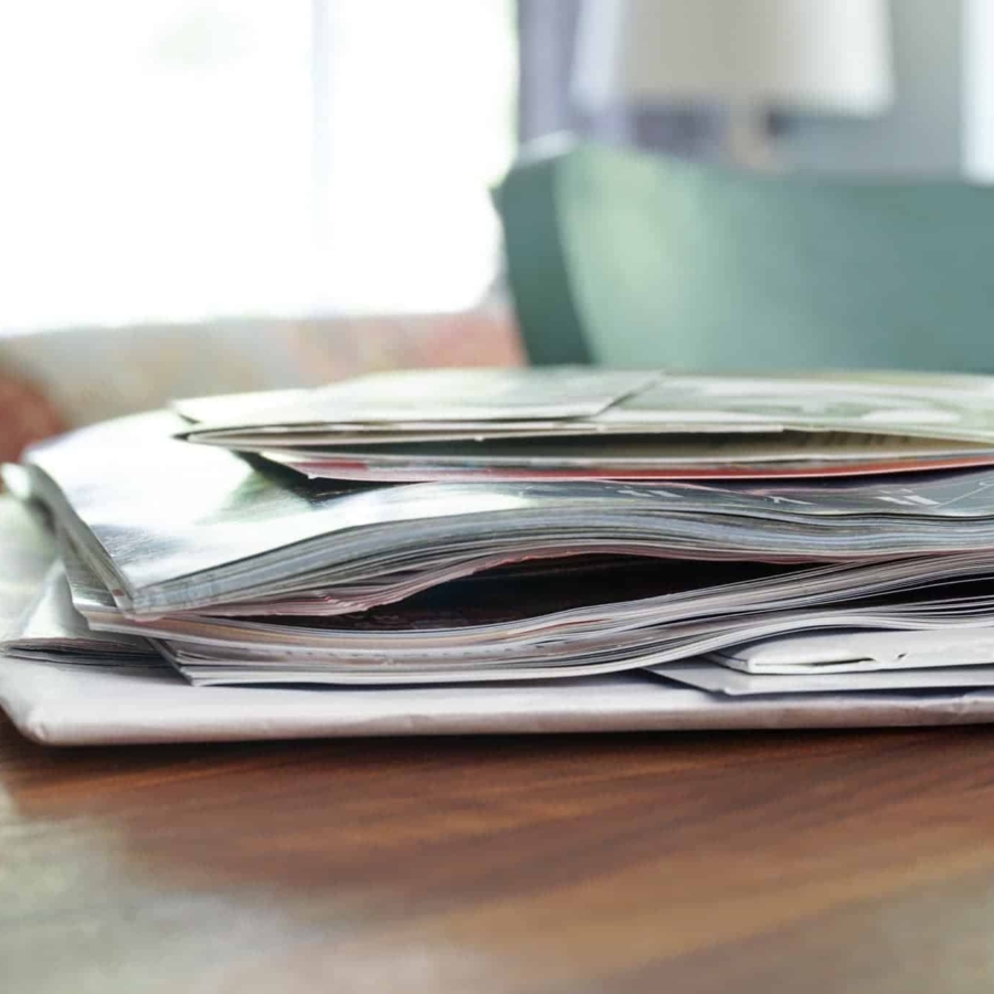 a small stack of papers and magazines