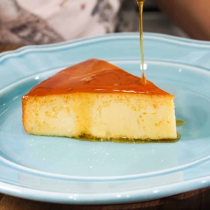 flan de leche on an aqua plate