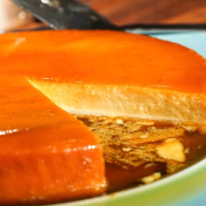 a partially cut creamy leche flan