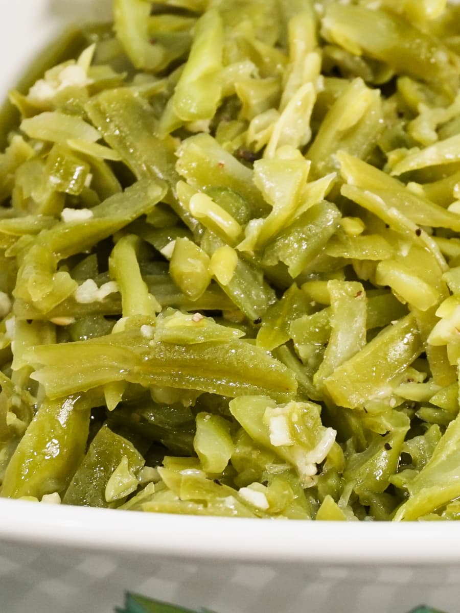 a serving bowl filled with delicious garlic butter green beans