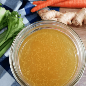 overhead shot of a large glass bowl bone broth