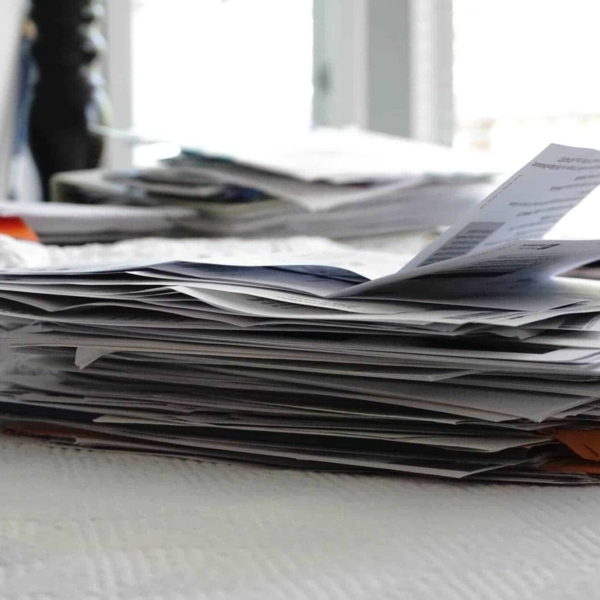 a pile of paper clutter sitting on a bed