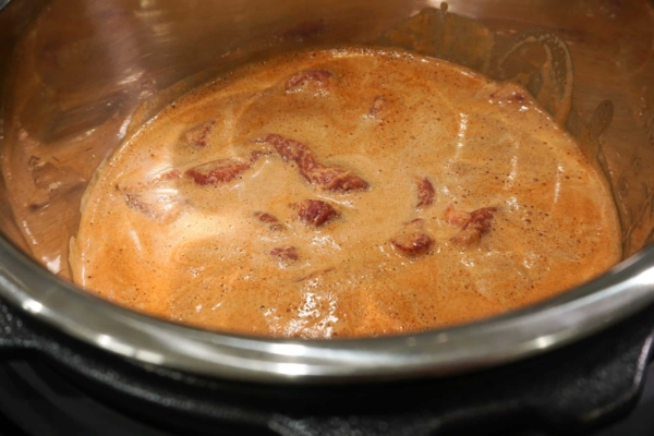all the ingredients for this cochinita pibil pulled pork recipe are added to the instant pot pressure cooker