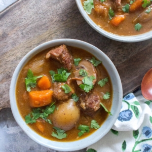 top view of a bowl of beef stew garnished with parsley