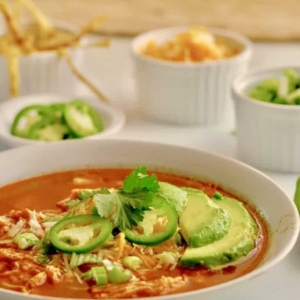 chicken tortilla soup in a bowl garnished with cilantro