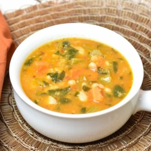 a bowl of homemade minestrone soup on a placemat