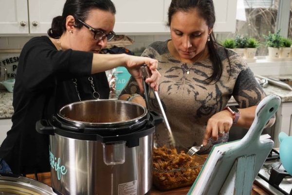 shredding the pork shoulder that just came out of the instant pot for making the pork carnitas, cochinita pibil