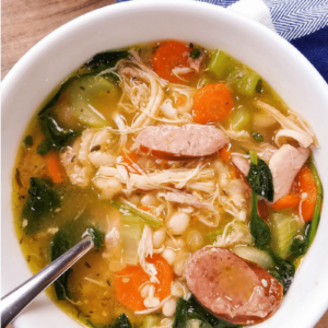 overhead view of veggie loaded chicken and sausage soup in a bowl