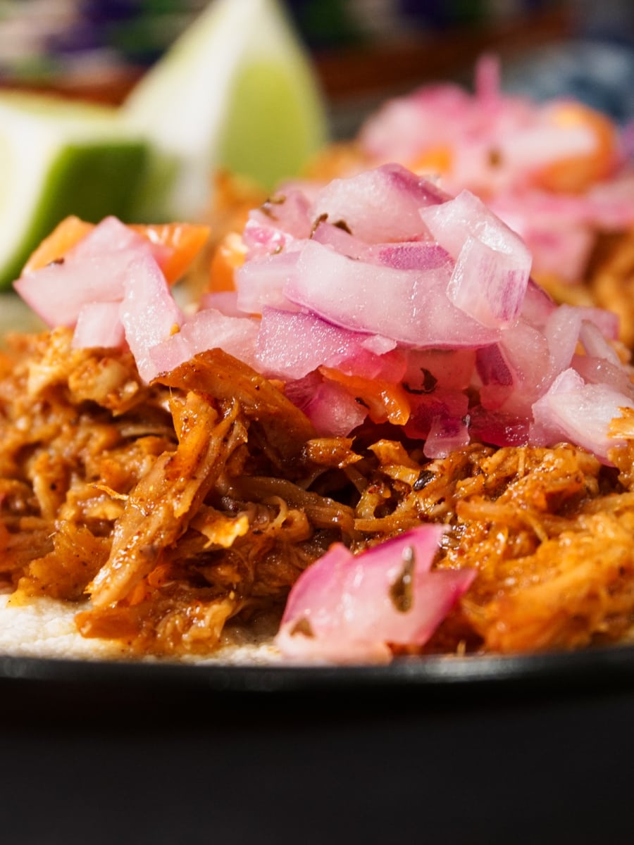 authentic mexican flavored pork carnitas tacos served on a plate